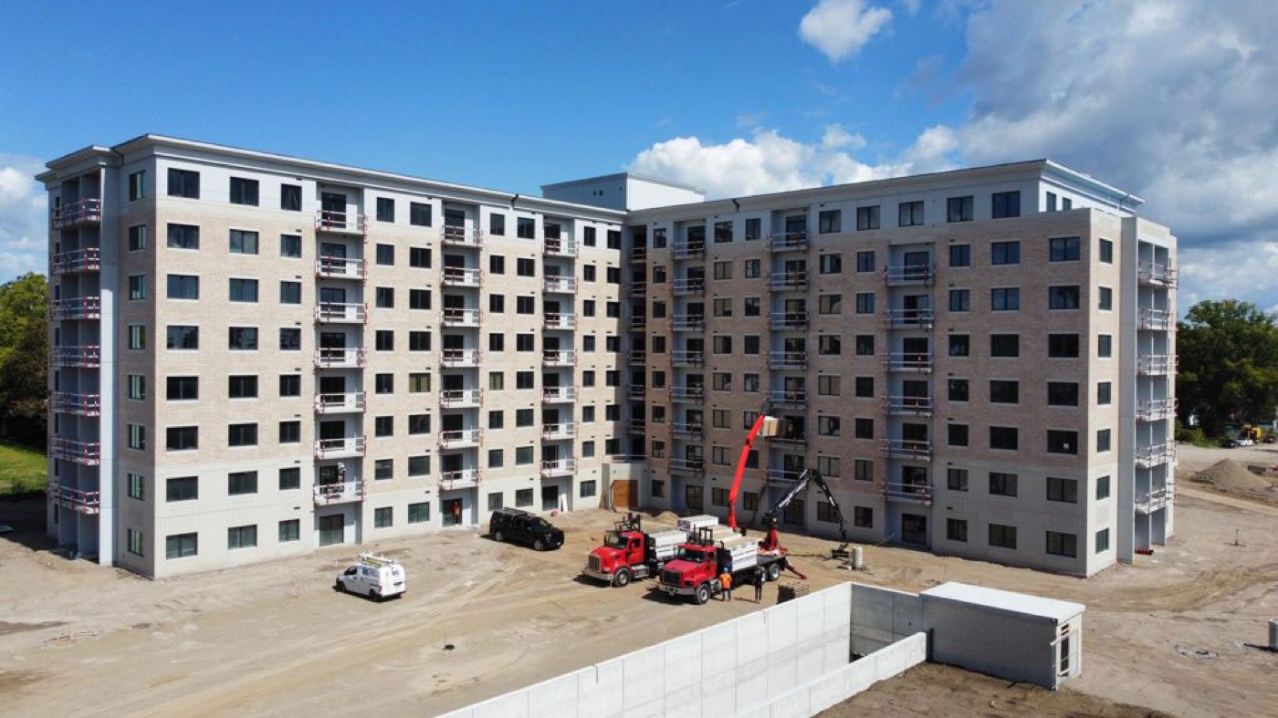 Mid-rise building under construction with pattern precast panels going up