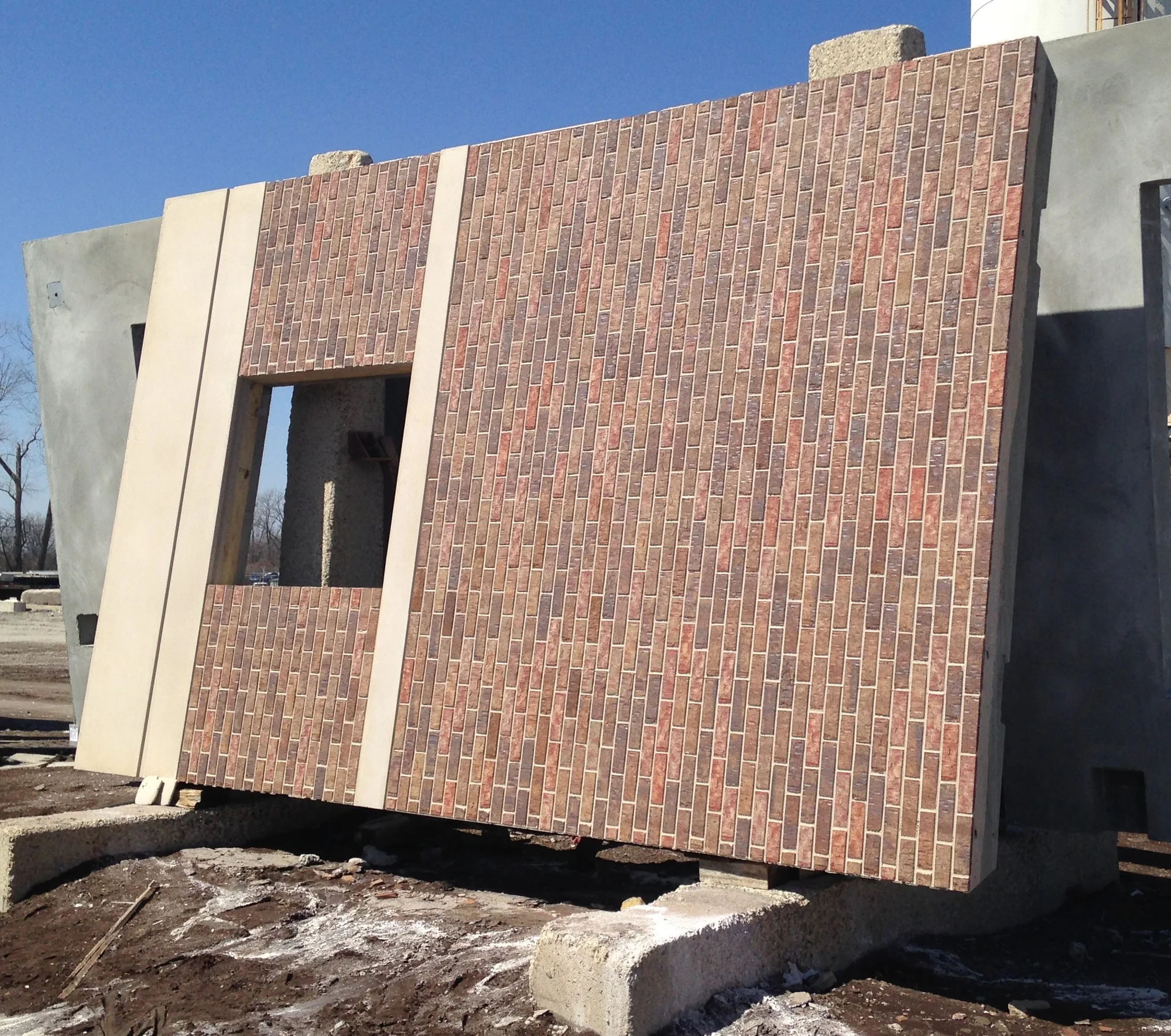 A brick-faced precast panel with the brick and the joints cast into the face