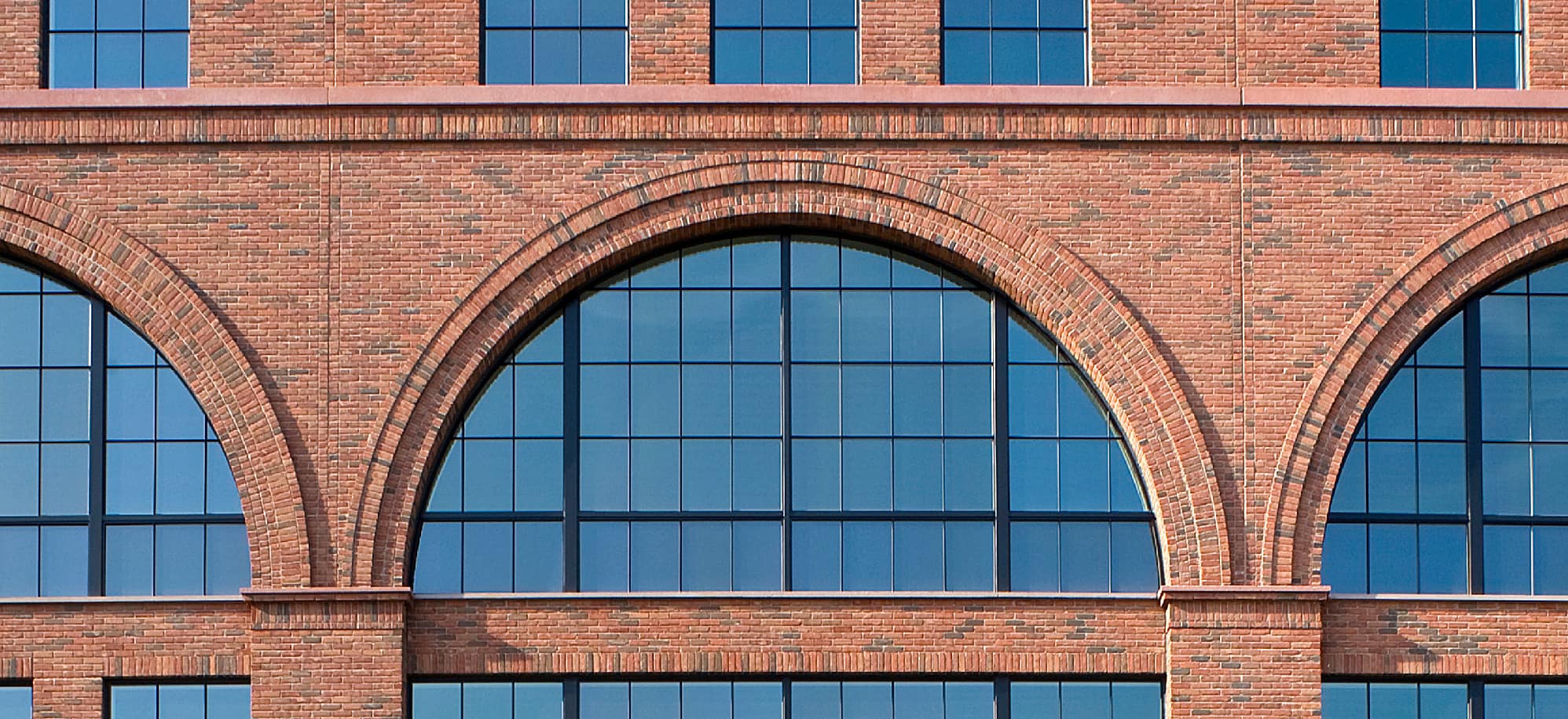 Arched red brick facade cast with Advanced embedded thin brick