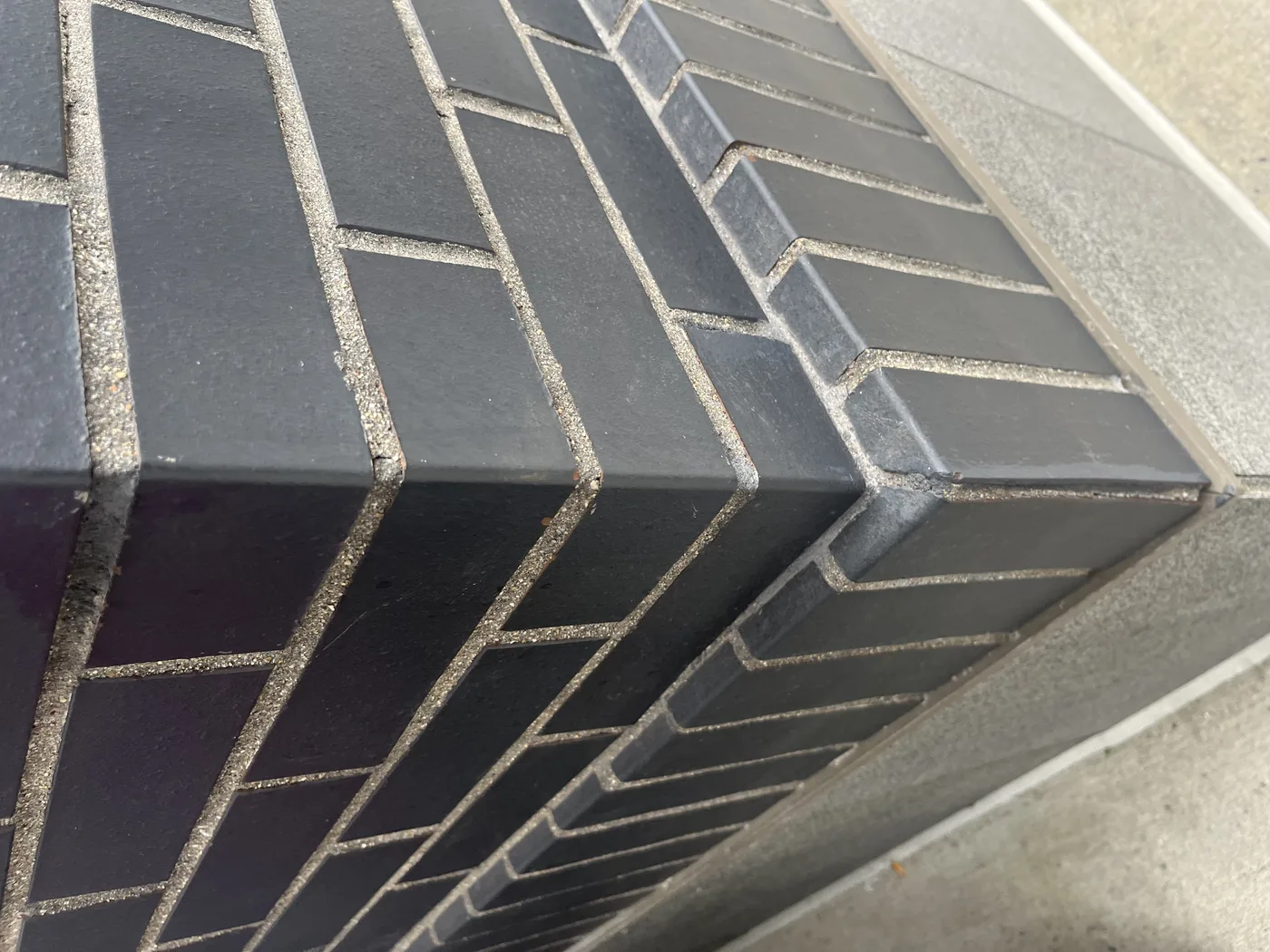 Thin brick meeting a panel edge up close, 10 Taber Street, Boston